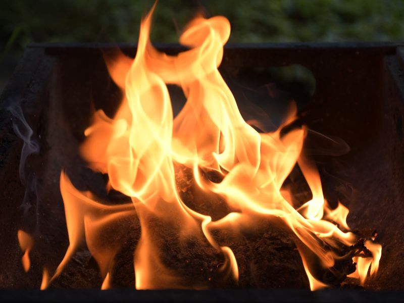 Навпроти каміну із вогнищем сім'я гріє ноги , ми бачимо ноги дорослого чоловіка, жінки та посередині ніжки дитячі.